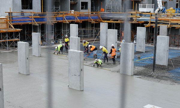Builders preparing the concrete footings of the building
