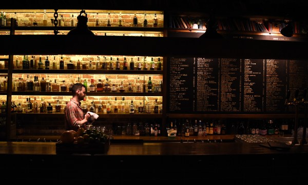 Bank Street Social interior of bar with menu board and bottles on shelves