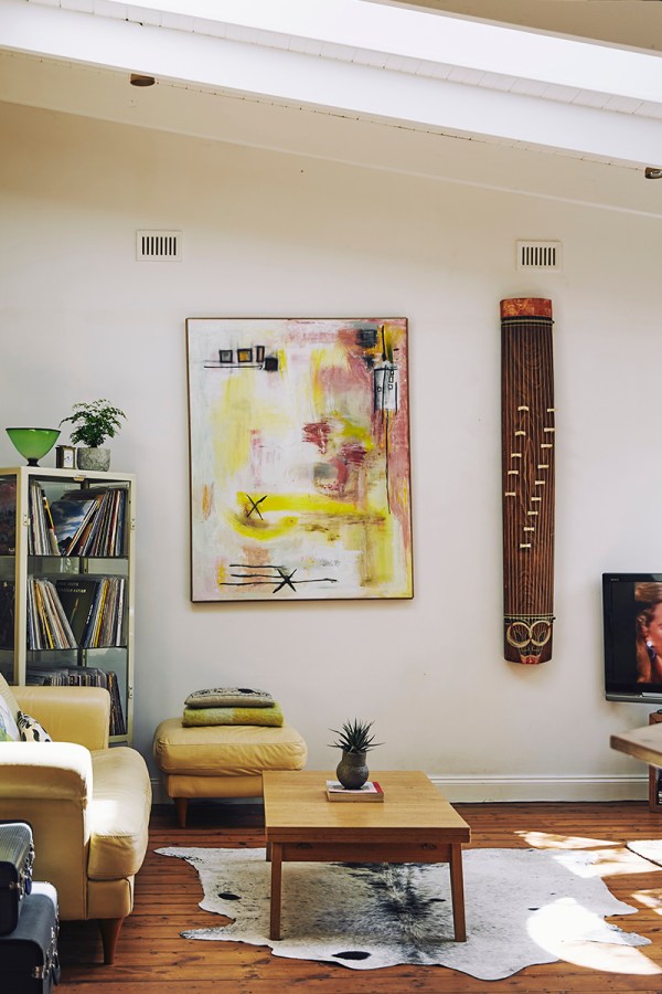 An eclectic collection of art lines the walls and sits upon surfaces high and low