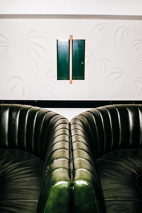 Green leather booths and rendered wall Golden Boy Cellar