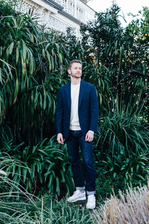 tailored jacket worn with jumper, jeans and sneakers